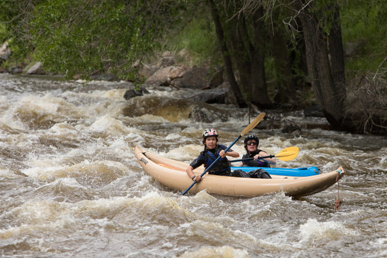 Two kayakers in Mad Dog rapid on the Poudre River