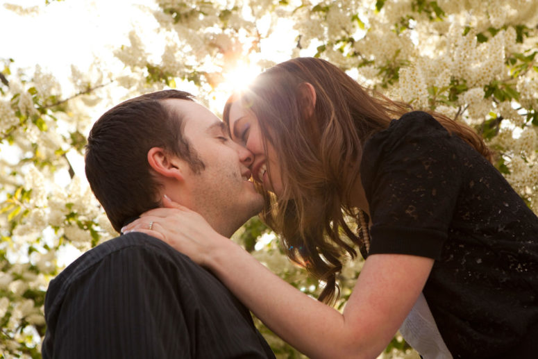 engagement photographer couple in tree blooms