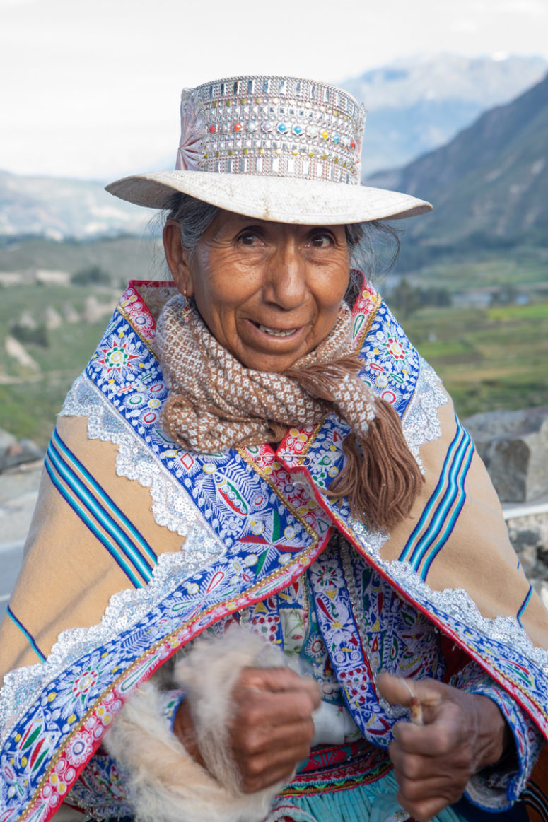 A Peruvian woman makes thread near Colca Canyon, Peru.