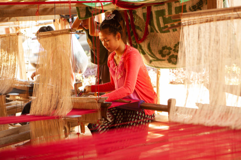 girl at loom in laos