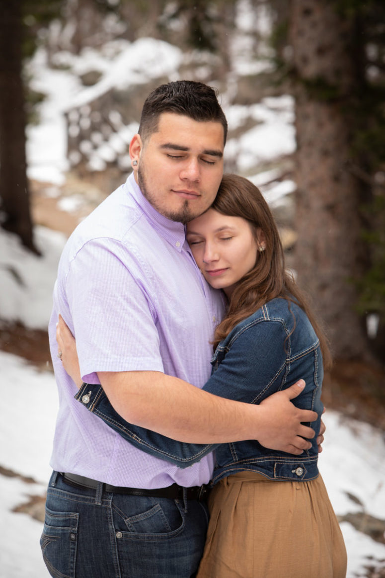 engagement photography couple hugging with eyes closed