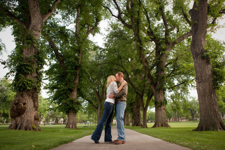 couple kissing at CSU Oval Fort Collins