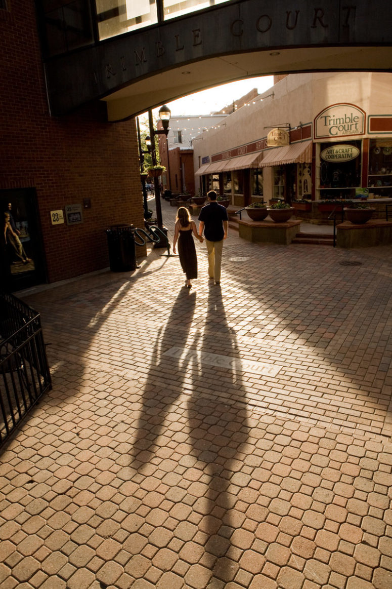 couple walking through old town fort collins