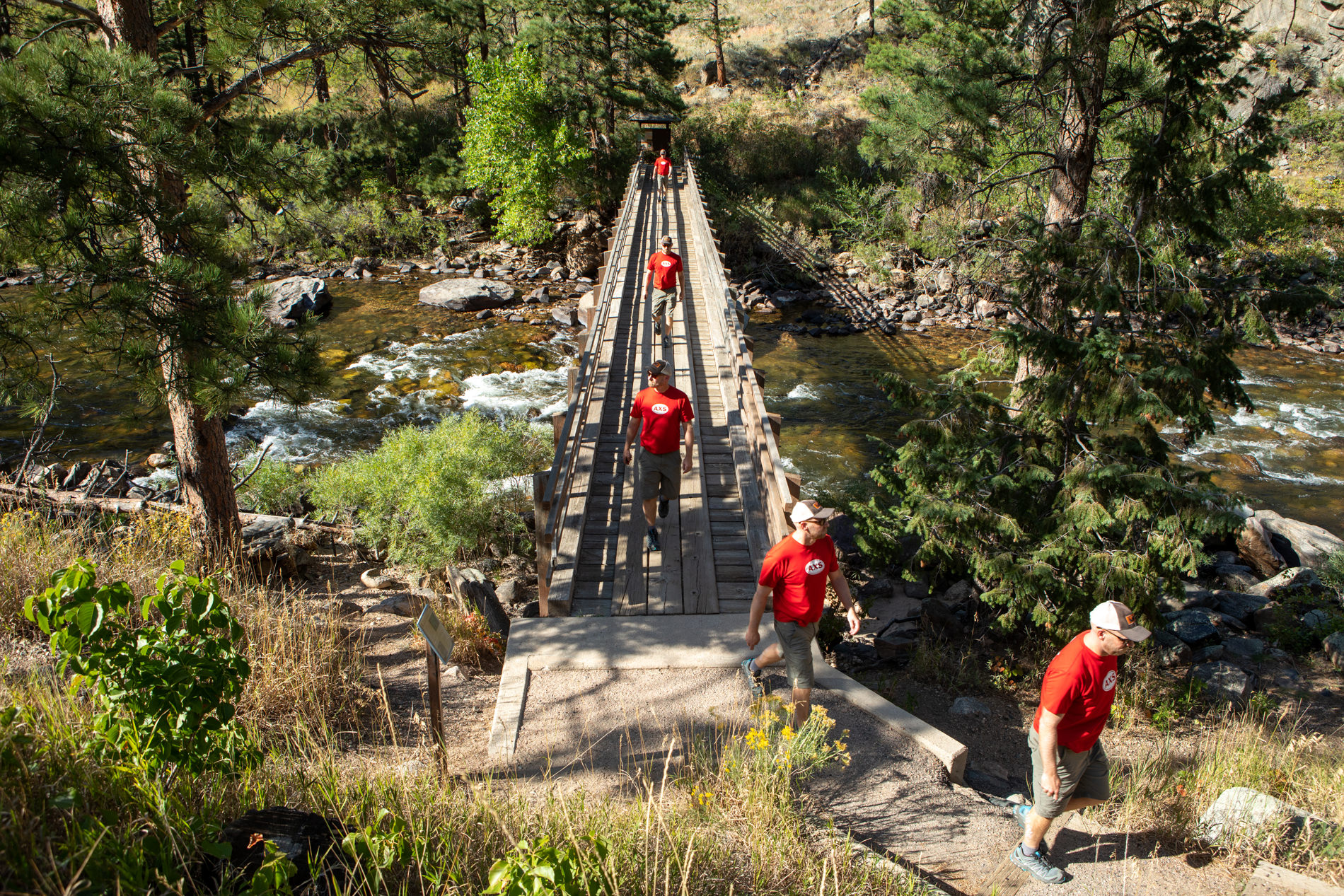 A hiker crosses the Greyrock Trail bridge
