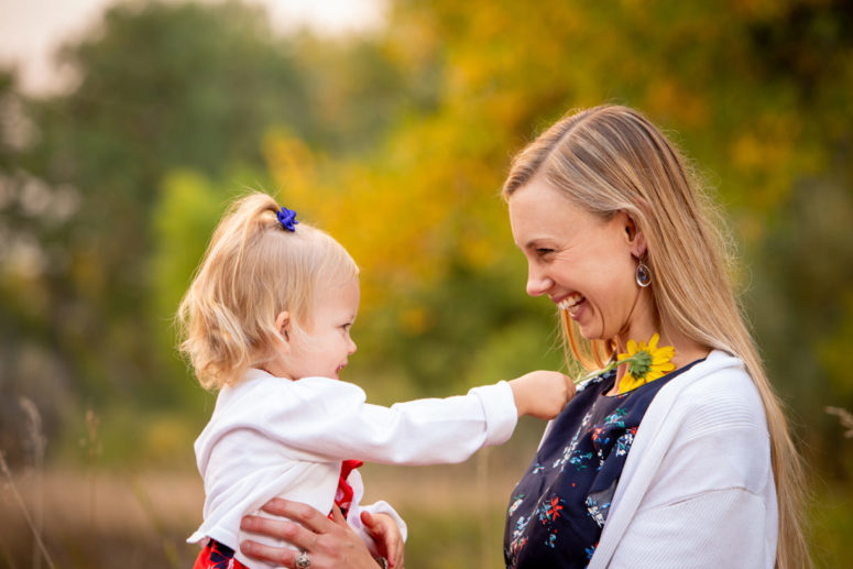 fort collins family photographer girl with flower