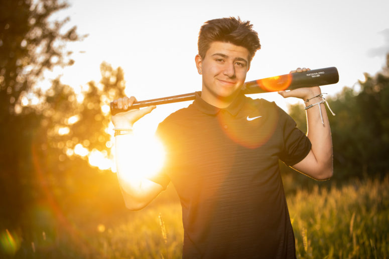 senior portrait of athlete with baseball bat