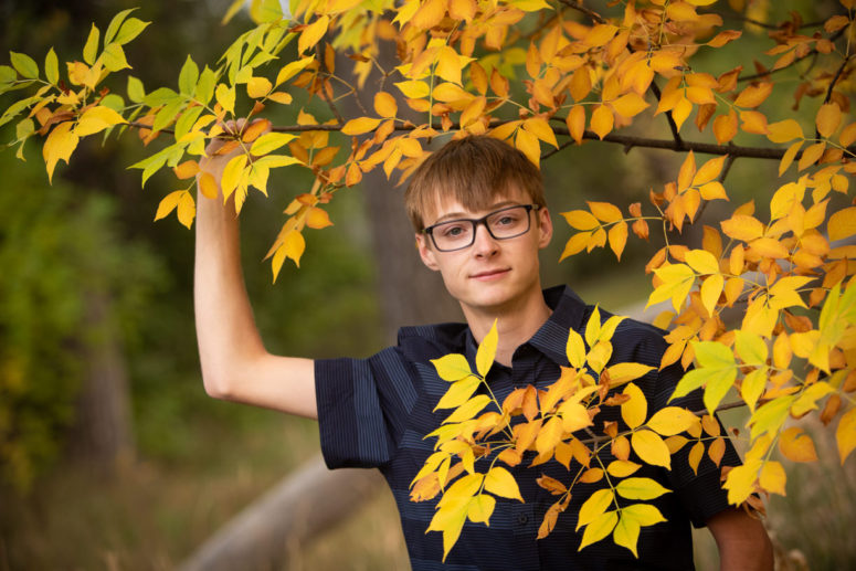 senior portrait guy in fall foliage