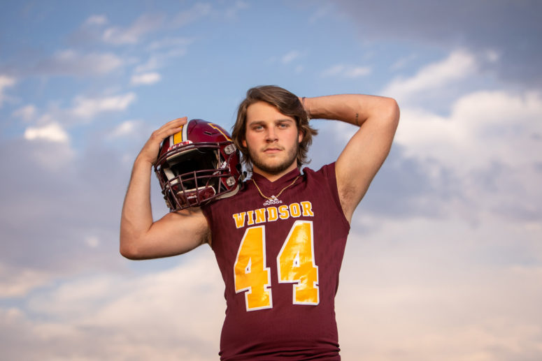 senior portrait photography with football helmet