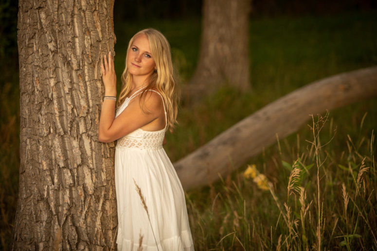 senior portrait photography of girl against tree