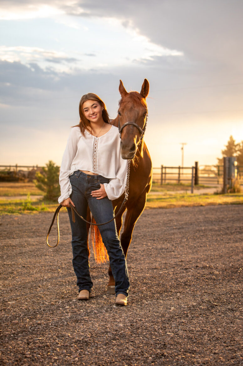 Portrait of a girl and her horse at dusk.