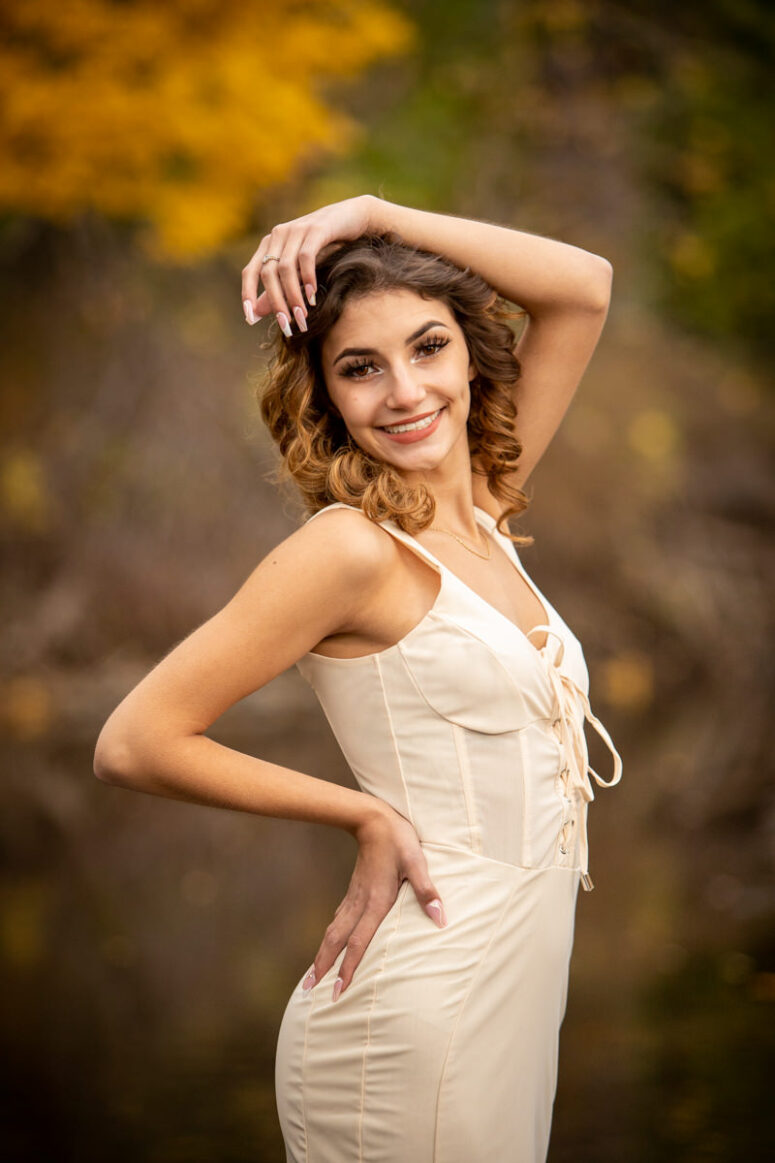 A girls in nature smiling at the camera.