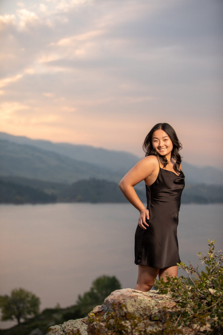 A smiling high school senior overlooking Horsetooth Reservoir.