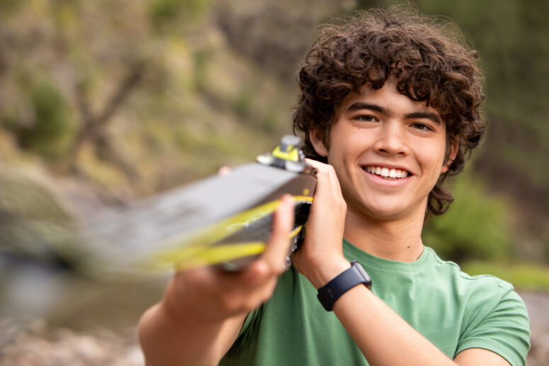 High school senior posing with skis.